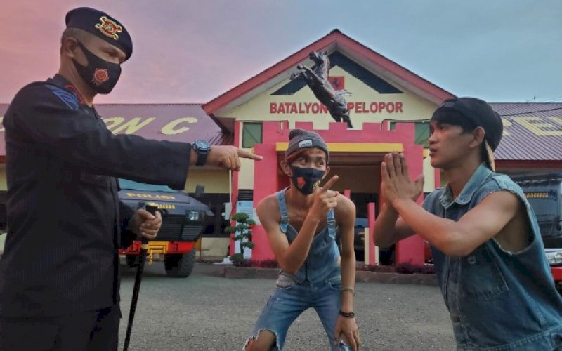 ADEGAN. Komandan Batalyon (Danyon) C Pelopor Satbrimob Polda Sulsel, Kompol Nur Ichsan (kiri) pada penggarapan video klip baru mereka yang berjudul 'Patuhi 3M'. foto: istimewa