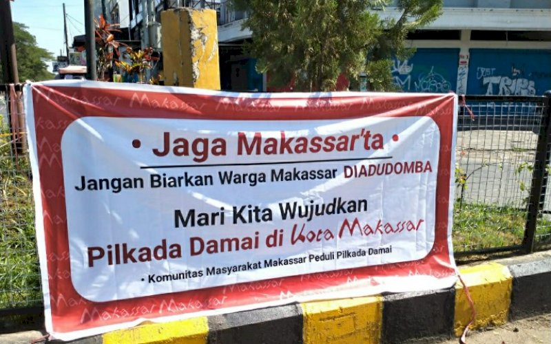 IMBAUAN. Salah satu spanduk imbauan Pilwalkot Makassar Damai terpasang di pinggir jalan seperti terekam, Rabu (11/11/2020). foto: istimewa