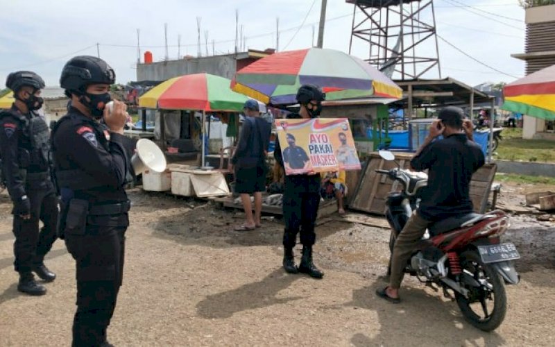 PATROLI. Personel Batalyon C Pelopor Satbrimob Polda Sulsel melaksanakan patroli dan mengimbau kepada masyarakat untuk disiplin menerapkan protokol kesehatan pencegahan Covid-19 di tempat-tempat keramaian, Minggu (7/2/2021). foto: humas brimob bone