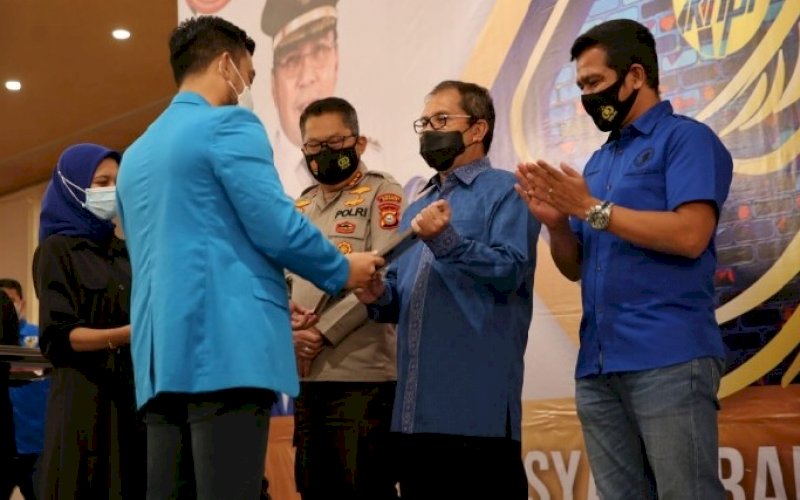 PENGHARGAAN. Ketua KNPI Kota Makassar Ryo Christopher Aviary menyerahkan penghargaan kepada Wali Kota Makassar Moh Ramdhan Pomanto di acara Musda XV KNPI Kota Makassar di Hotel Myko Makassar, Jumat (9/4/2021). foto: humas pemkot makassar