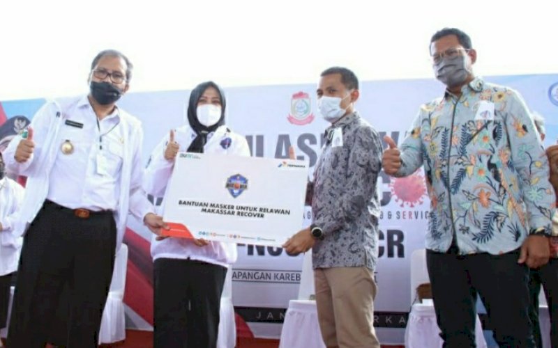 TERIMA BANTUAN. Wakil Wali Kota Makassar Fatmawati Rusdi mendampingi Wali Kota Makassar Moh Ramdhan Pomanto menerima bantuan 5.000 masker yang disumbangkan Pertamina di Tribun Lapangan Karebosi Makassar, Rabu (7/4/2021). foto: humas pemkot makassar