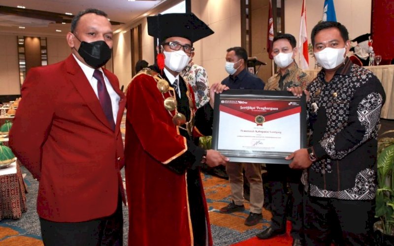 PENGHARGAAN. Rektor IBK Nitro Dr Moh Hatta Alwi Hamu menyerahkan penghargaan kepada kabag Umum Setda Pemkab Enrekang Umaruddin di sela-sela Wisuda XXXVIII IBK Nitro di Hotel Claro Makassar, Rabu (23/6/2021). foto: istimewa