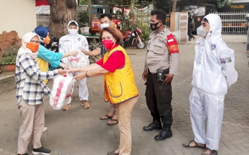 BERBAGI. Lions Club Makassar Rajawali (LCMR) menggelar kegiatan fundraising dengan membagikan sekitar 320 nasi dos kepada masyarakat Kota Makassar yang terdampak pandemi Covid-19, Sabtu (7/8/2021). foto: istimewa