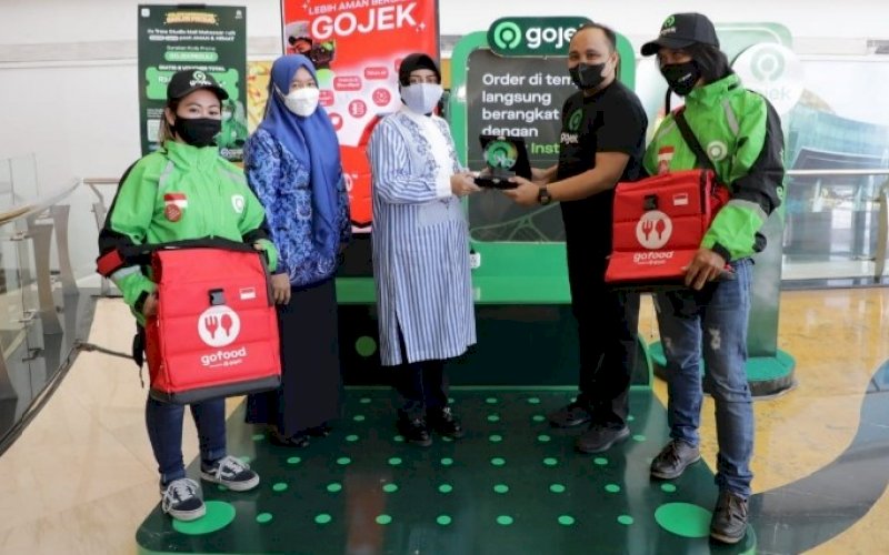 PENYERAHAN. Senior Manager Public Policy and Government Relations Gojek Sulawesi Mohammad Khomeiny menyerahkan plakat penghargaan kepada Ketua Tim Penggerak PKK Kota Makassar Indira Jusuf Ismail di Trans Studio Mal Makassar, Jumat (17/9/2021). foto: istimewa