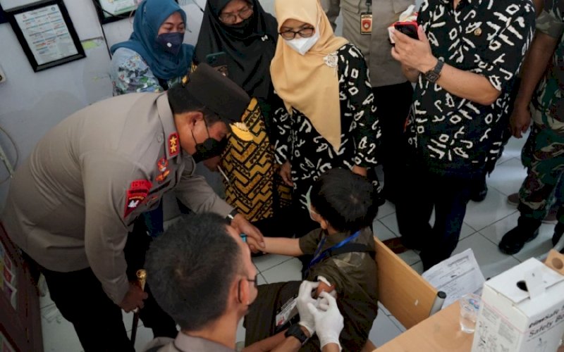 BERI MOTIVASI. Kapolda Sulsel, Irjen Pol Nana Sudjana, memberikan motivasi kepada siswa SD saat memantau langsung pelaksanaan vaksinasi di SDN Kompleks IKIP Makassar, Jl AP Pettarani, Kota Makassar, Jumat (11/3/2022). foto: doelbeckz/pluz.id