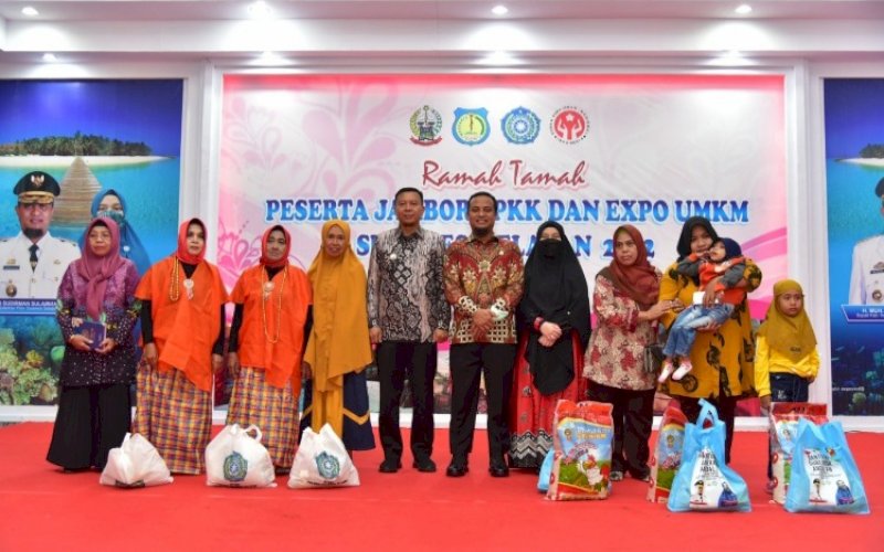 BAGIKAN SEMBAKO. Gubernur Sulsel Andi Sudirman Sulaiman dan Ketua TP PKK Sulsel Naoemi Octarina membagikan ratusan paket sembako pada Jambore PKK Sulsel di Kabupaten Kepulauan Selayar, Rabu (23/11/2022). foto: istimewa