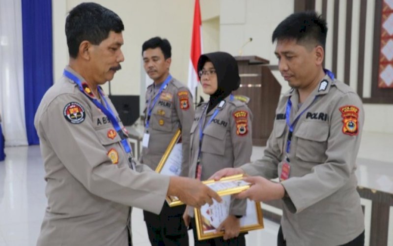 PENGHARGAAN. Kombes Pol Komang Suartana Kabid Humas Polda Sulsel menyerahkan tiga penghargaan kepada Polres Palopo yang diwalili personel Bagian Seksi Humas Polres Palopo Bripka Rusdianto di Aula Mappaodang Polda Sulsel, Selasa (8/11/2022). foto: istimewa