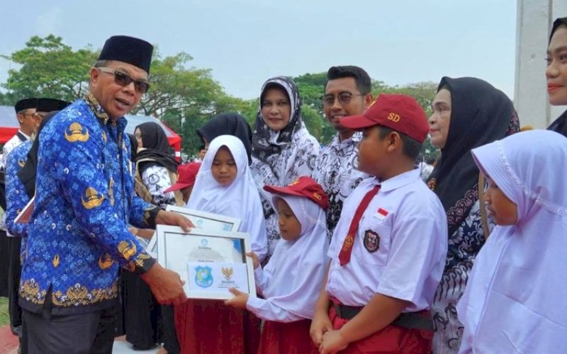 PENYERAHAN. Bupati Bulukumba, Andi Muchtar Ali Yusuf, secara simbolis menyerahkan seragam sekolah untuk siswa yang baru masuk SD dan SMP tahun ajaran 2025, Senin (30/6/2025). Bantuan seragam ini gratis dan bersifat stimulan. foto: istimewa