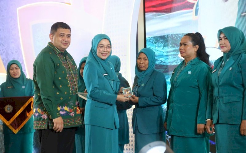 PENYERAHAN. Ketua TP PKK Kota Makassar Melinda Aksa Munafri bersama Wali Kota Makassar Munafri Arifuddin menyerahkan penghargaan secara langsung kepada para kader penerima Adibakti. foto: istimewa
